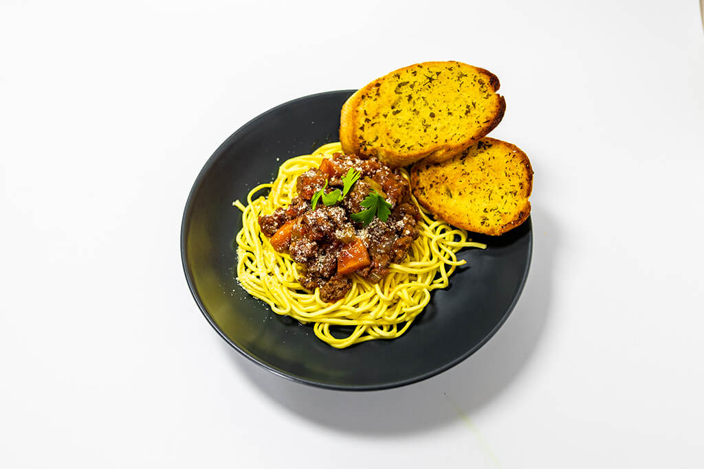 Spaghetti Bolognese with a side of garlic bread
