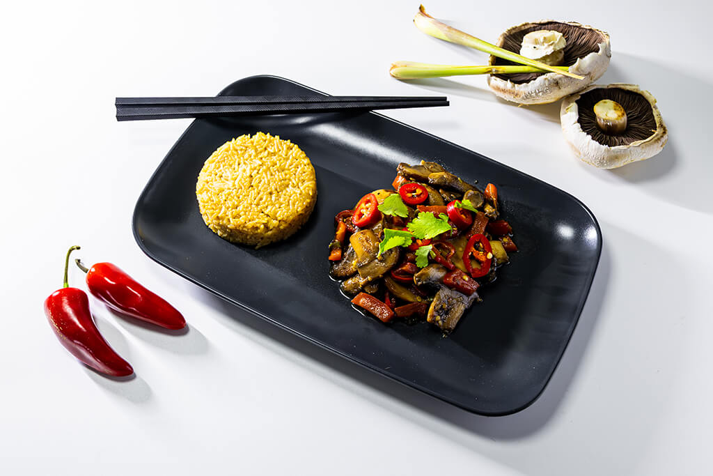 Salt & Pepper Mushrooms with Fried Rice. Chopsticks, mushrooms and chilies as decorations