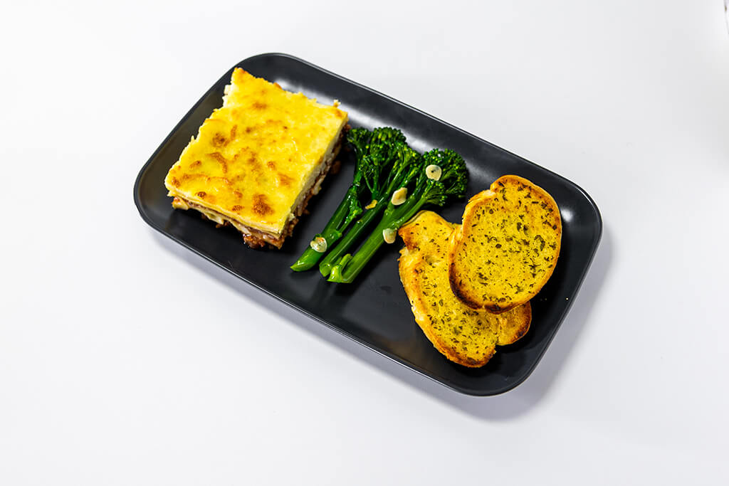 Lasagna with tender stem broccoli and garlic bread